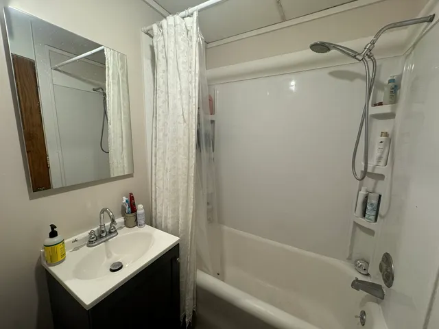 a bathroom with a sink mirror toilet and shower