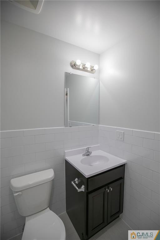 3405 Hana Road Edison, NJ 08817 - Photo 53 of 69 a bathroom with a sink vanity and a toilet