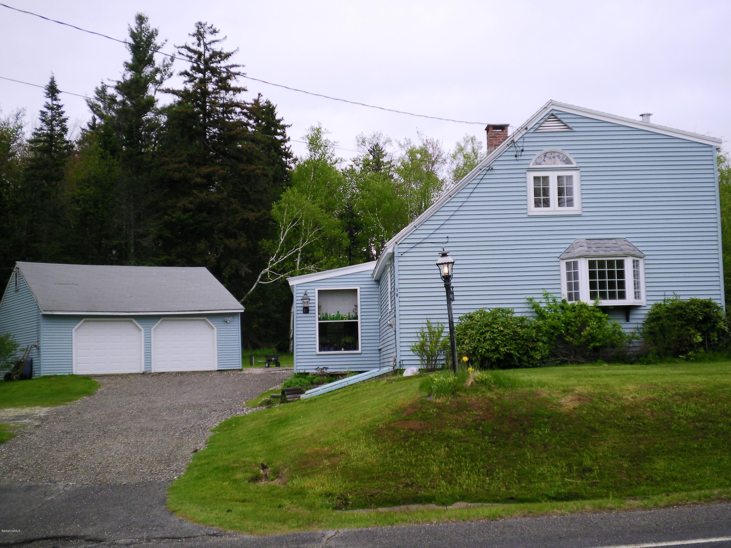 18 West Main Road Peru, MA 01235 - Photo 1 of 23 a front view of a house with a yard and garage