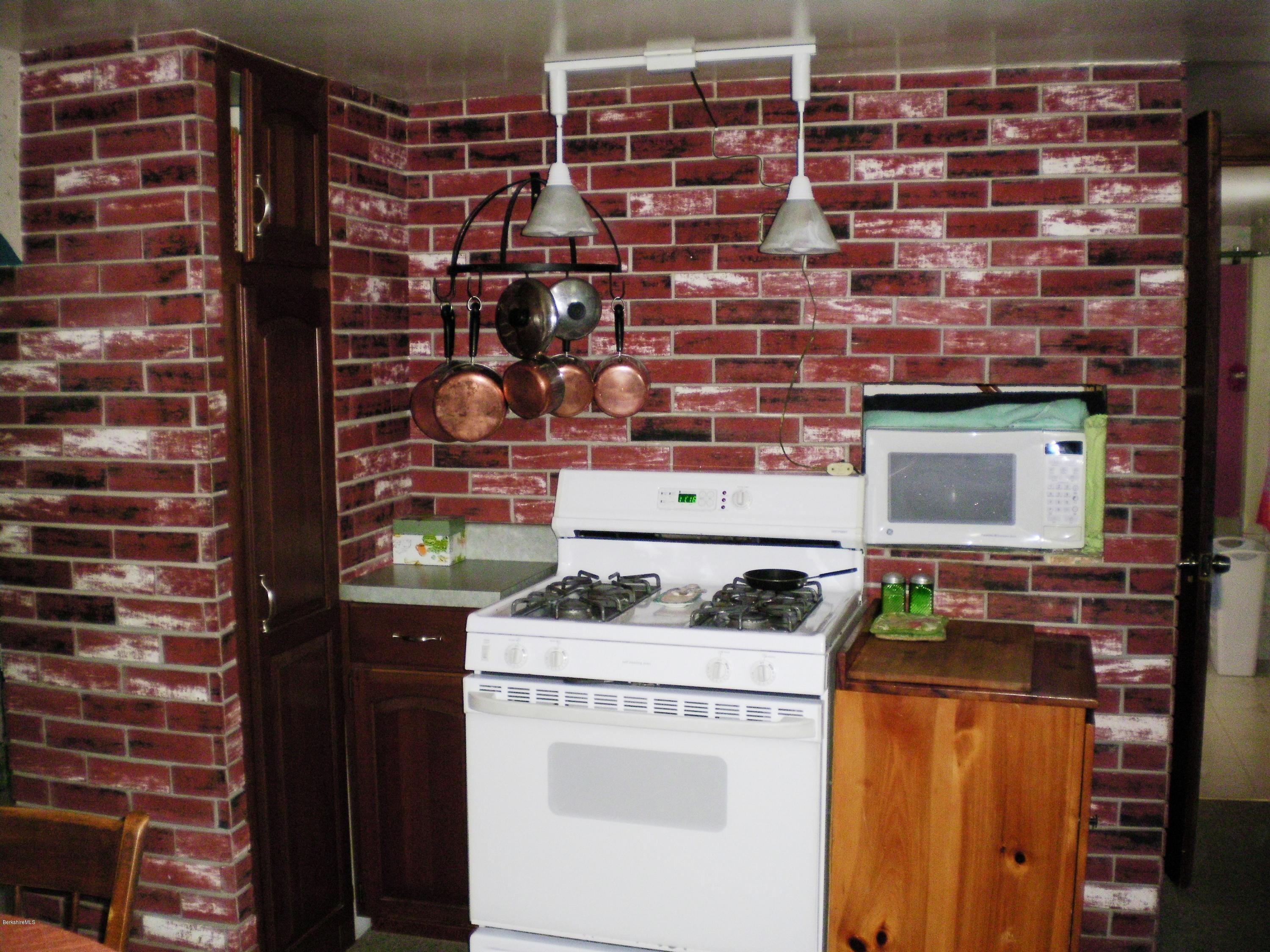 18 West Main Road Peru, MA 01235 - Photo 11 of 23 a kitchen stove top oven sitting inside of a kitchen