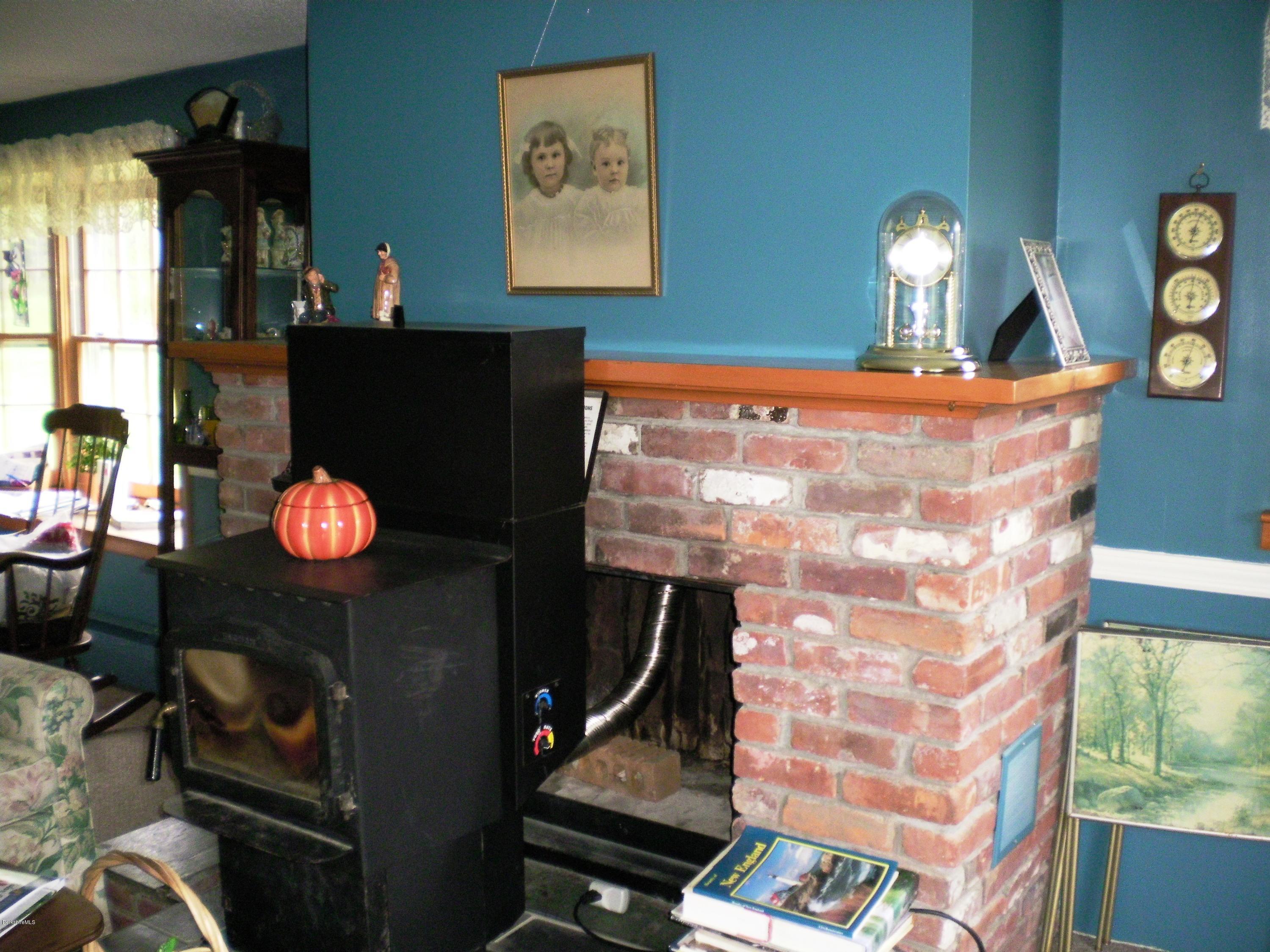 18 West Main Road Peru, MA 01235 - Photo 14 of 23 a lamp is sitting on a table in front of a house