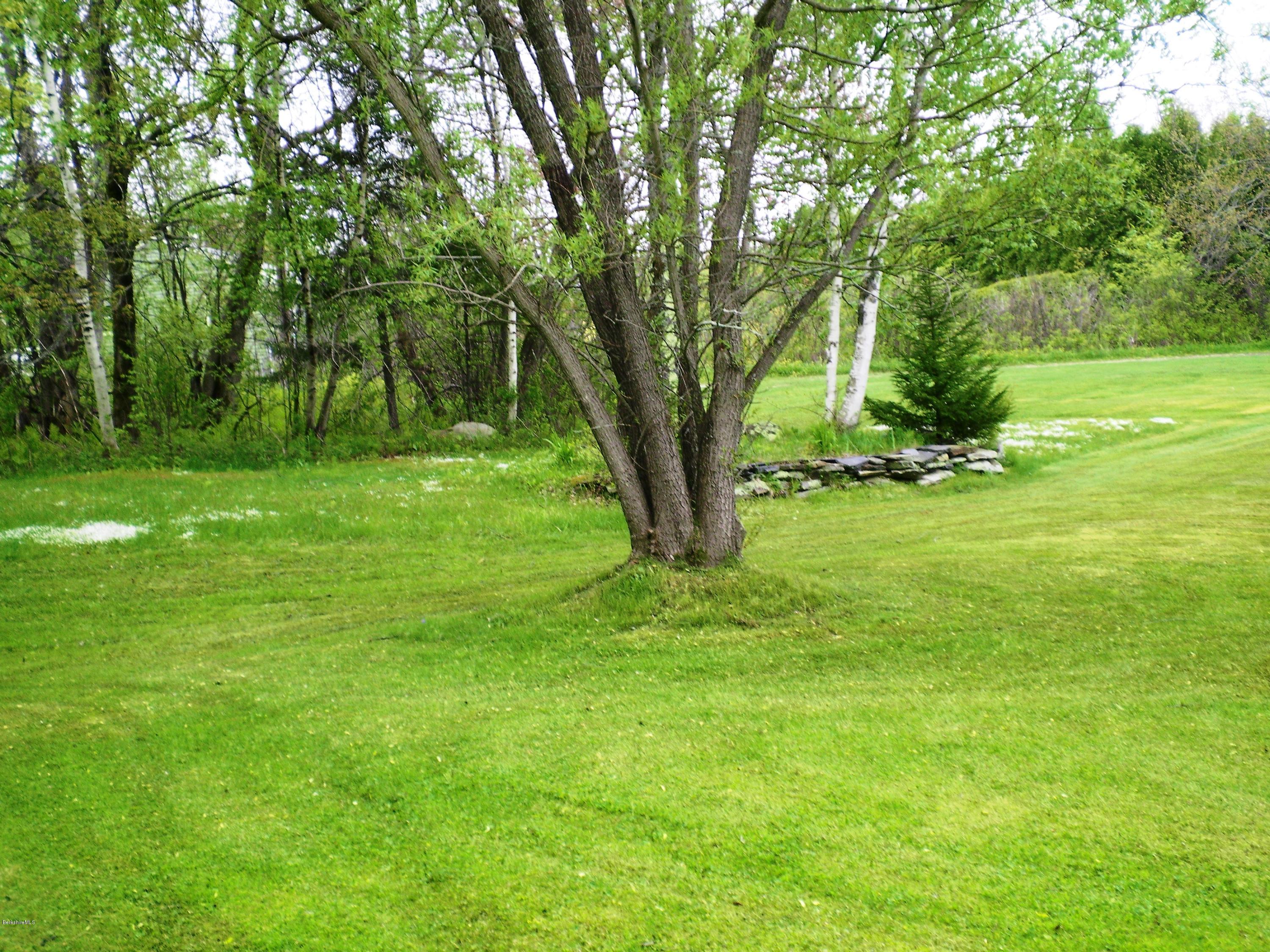 18 West Main Road Peru, MA 01235 - Photo 8 of 23 a view of a grassy field with trees in the background