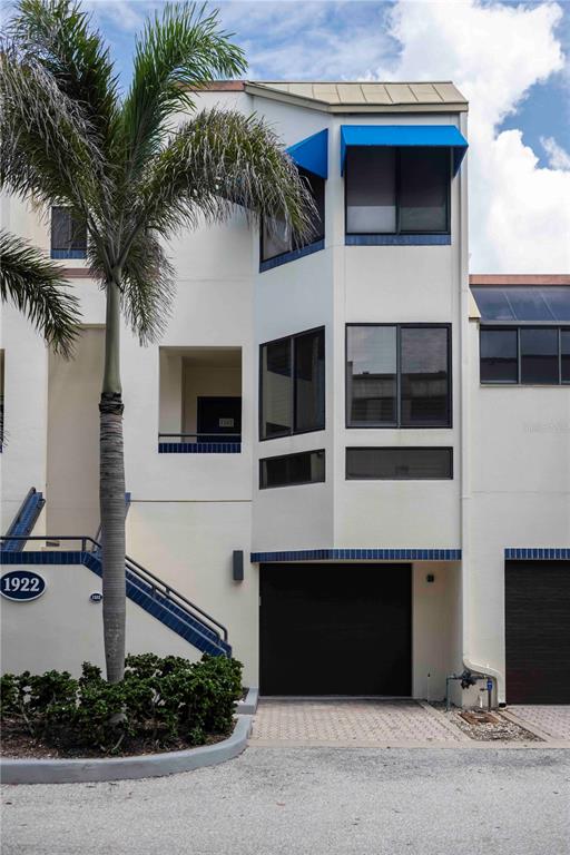 1922 Harbourside Drive, Unit 1102 Longboat Key, FL 34228 - Photo 1 of 23 a front view of a house with a yard