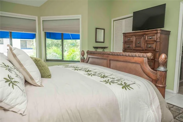 a bedroom with a bed and a flat screen tv