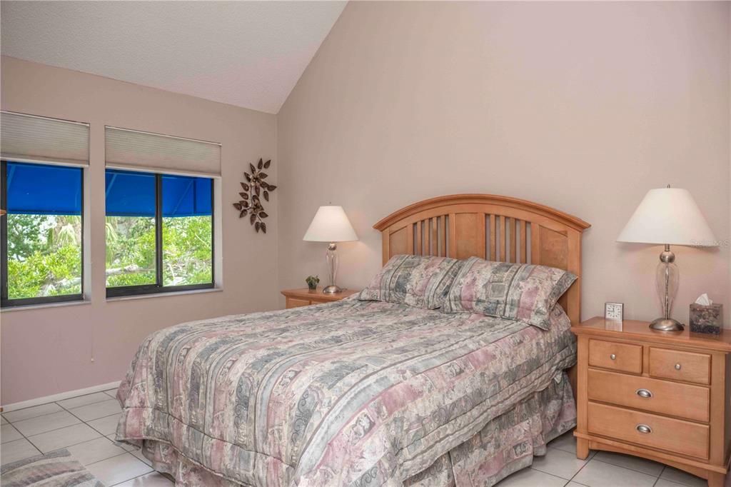 1922 Harbourside Drive, Unit 1102 Longboat Key, FL 34228 - Photo 13 of 23 a bedroom with a bed and a window