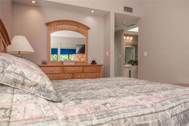 a bedroom with a bed and a mirror