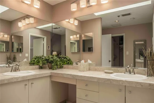 a bathroom with a sink double vanity and a mirror