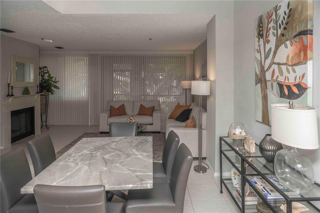 1922 Harbourside Drive, Unit 1102 Longboat Key, FL 34228 - Photo 2 of 23 a living room with furniture and a fireplace