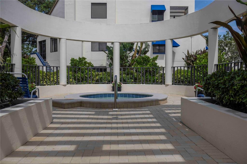 1922 Harbourside Drive, Unit 1102 Longboat Key, FL 34228 - Photo 21 of 23 a front view of a house with plants