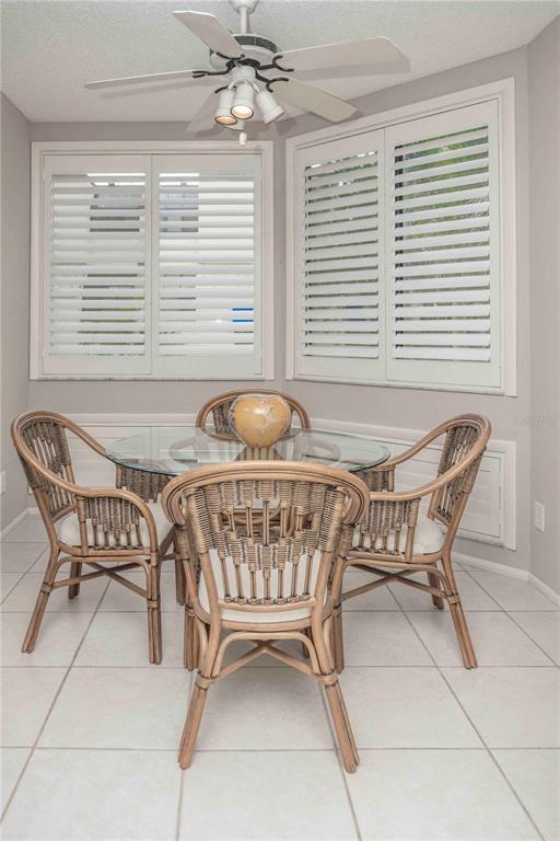 1922 Harbourside Drive, Unit 1102 Longboat Key, FL 34228 - Photo 5 of 23 a dining room with furniture and window