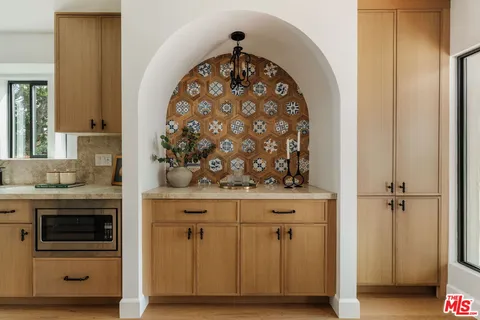a stove top oven sitting inside of a kitchen