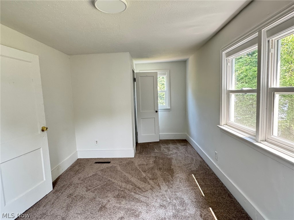 459 Patterson Avenue Akron, OH 44310 - Photo 12 of 24 2nd floor apt. Rear bedrm. Carpeted room with a textured ceiling