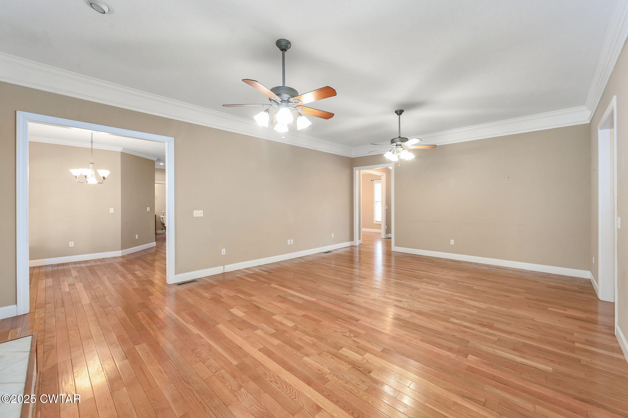 495 Sycamore Lane McKenzie, TN 38201 - Photo 7 of 21 a view of an empty room with chandelier fan and wooden floor