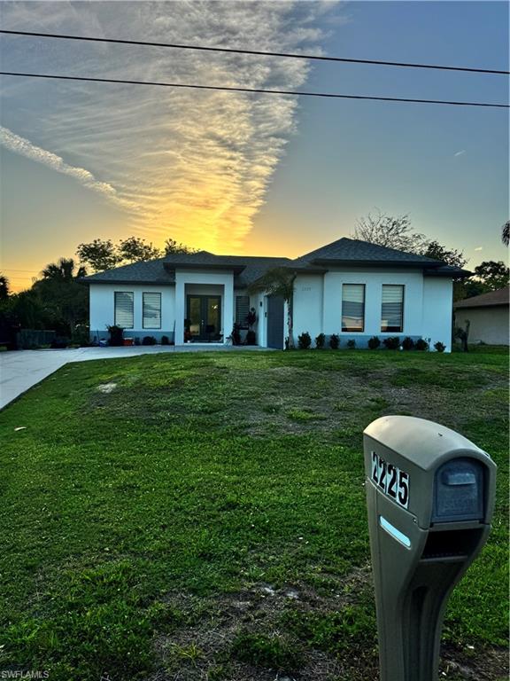 a view of a house with a backyard