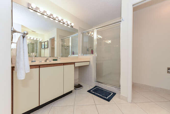 602 Mainsail Circle Jupiter, FL 33477 - Photo 11 of 39 a bathroom with a double vanity sink a mirror and a shower