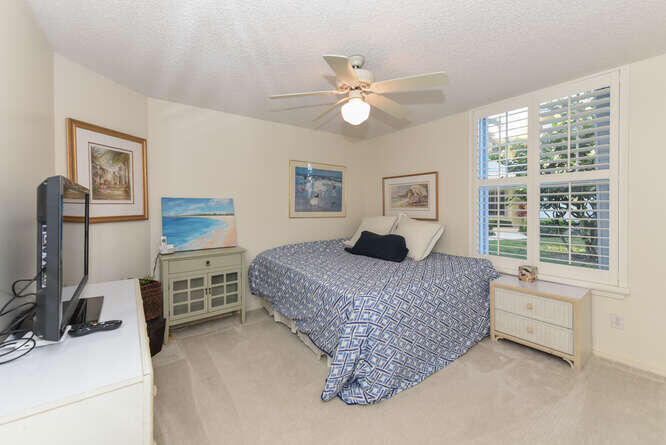 602 Mainsail Circle Jupiter, FL 33477 - Photo 13 of 39 a bedroom with a bed dresser and a window