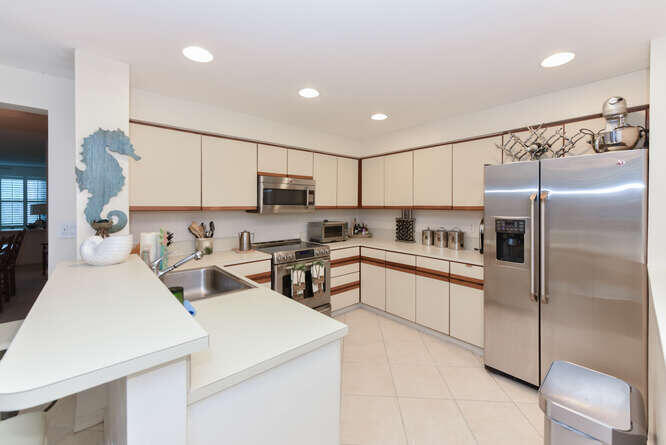 602 Mainsail Circle Jupiter, FL 33477 - Photo 20 of 39 a kitchen with stainless steel appliances a refrigerator sink and microwave