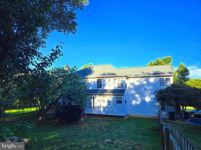 a living room with a fireplace and a wooden floor