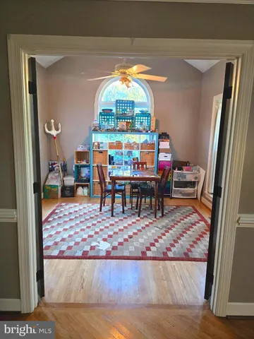 a view of a room with wooden floor and door