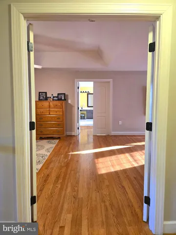 a bathroom with a sink a toilet a mirror and shower