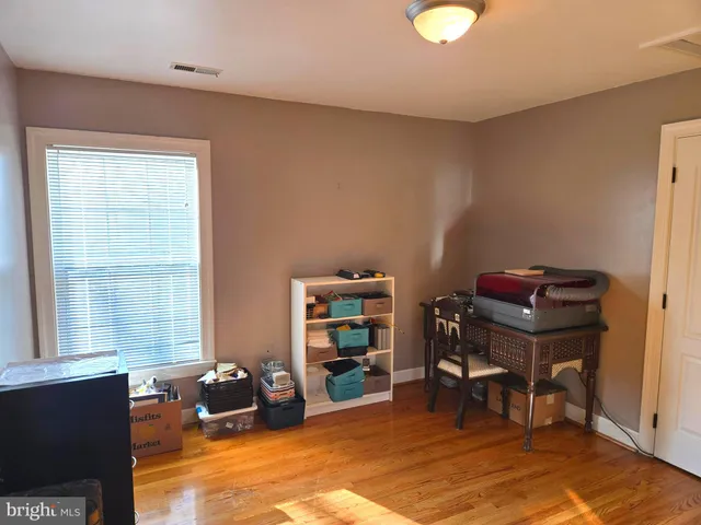 a view of swimming pool with lawn chairs and large trees