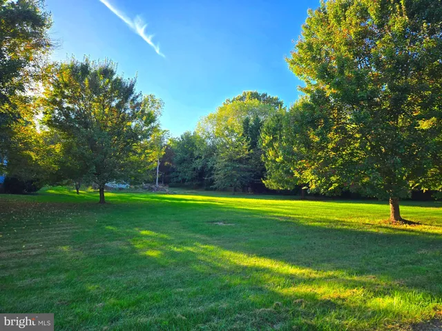 a view of entryway bedroom and hall with wooden floor