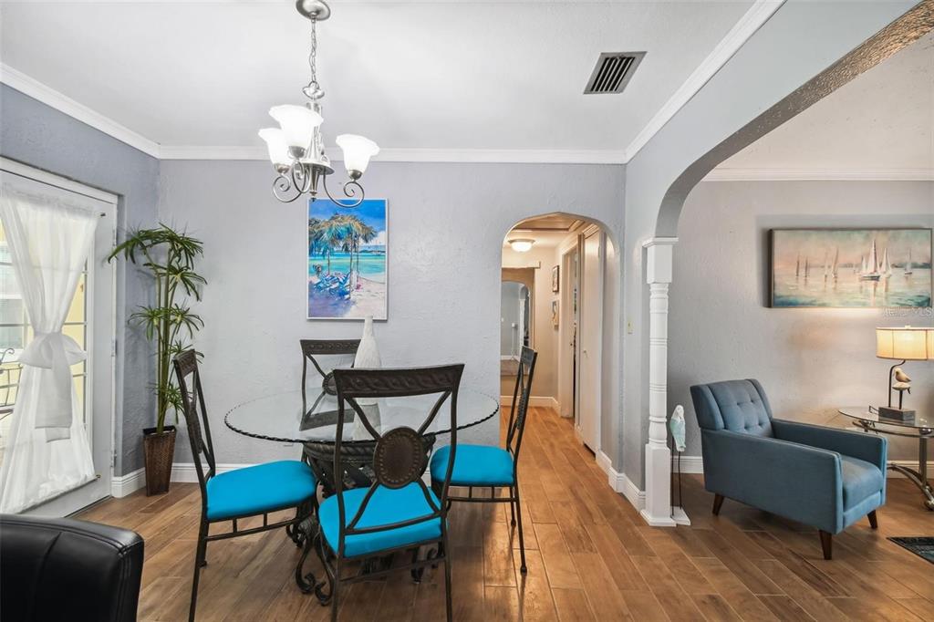 3915 North Ridge Avenue Tampa, FL 33603 - Photo 12 of 52 a living room with furniture a dining table and a chandelier