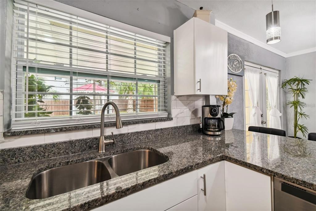 3915 North Ridge Avenue Tampa, FL 33603 - Photo 18 of 52 a kitchen with granite countertop a sink and a window