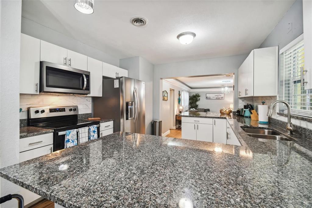 3915 North Ridge Avenue Tampa, FL 33603 - Photo 19 of 52 a kitchen with stainless steel appliances a stove a sink a microwave a refrigerator and cabinets