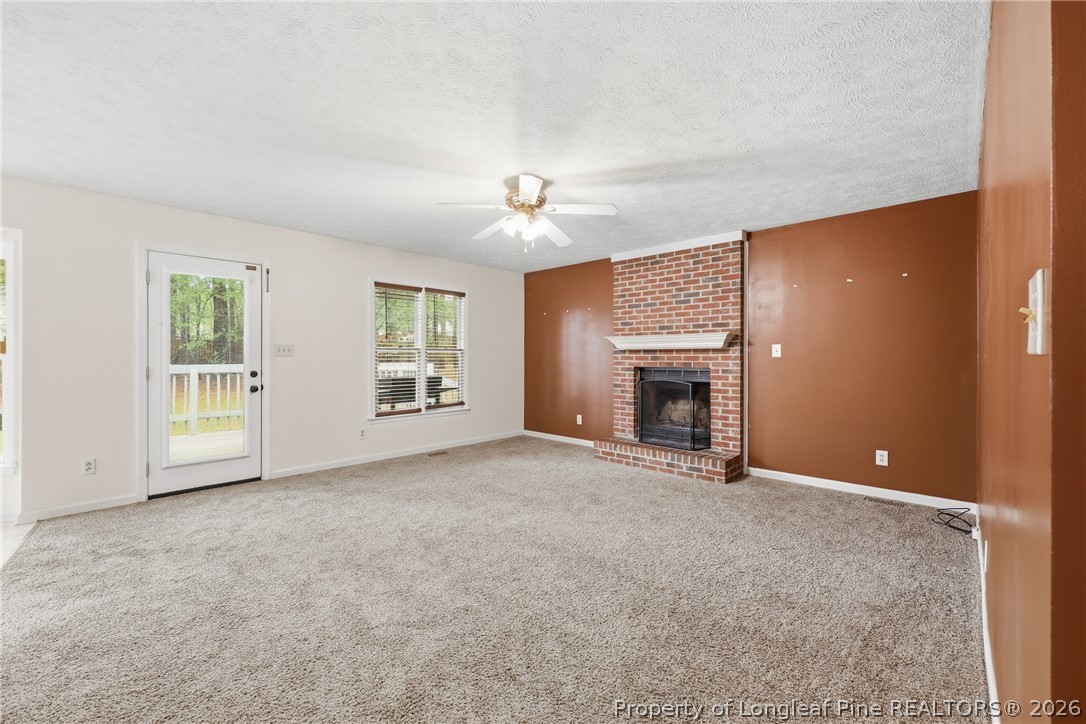 207 Cobblestone Court Raeford, NC 28376 - Photo 14 of 35 an empty room with windows and fireplace