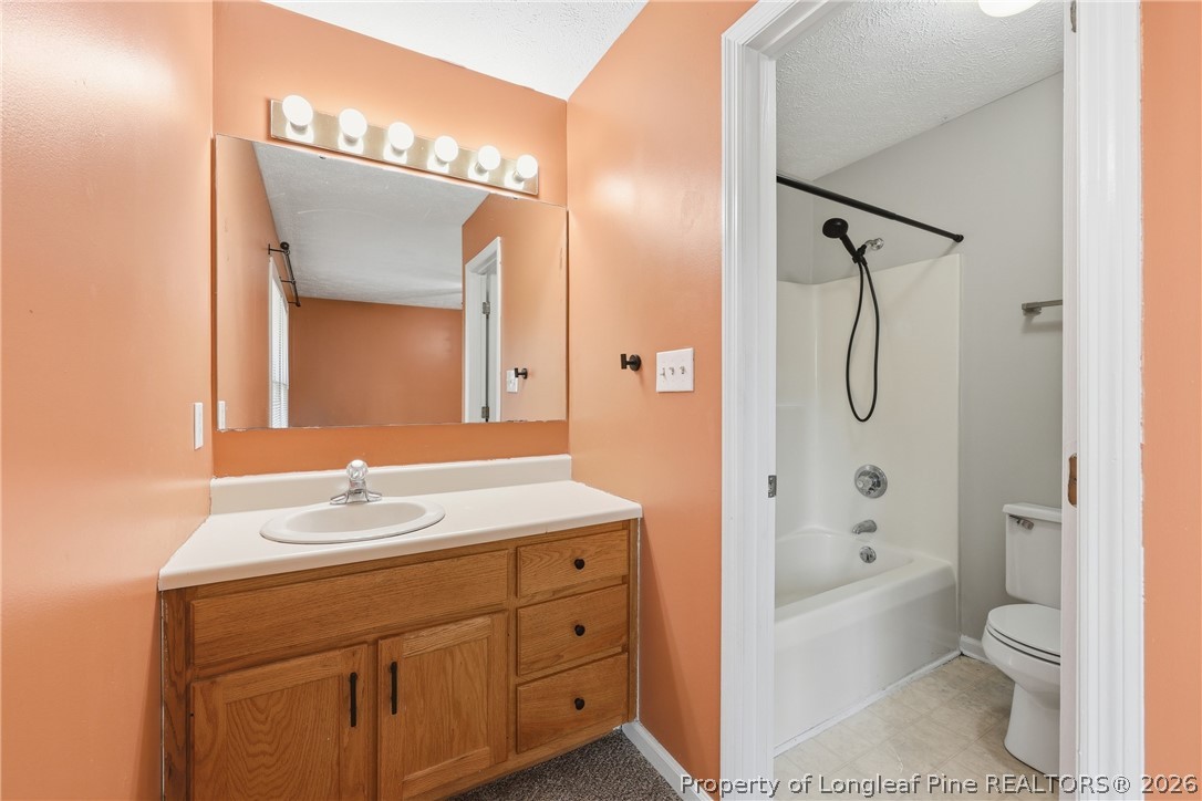 207 Cobblestone Court Raeford, NC 28376 - Photo 18 of 35 a bathroom with a sink a toilet and shower