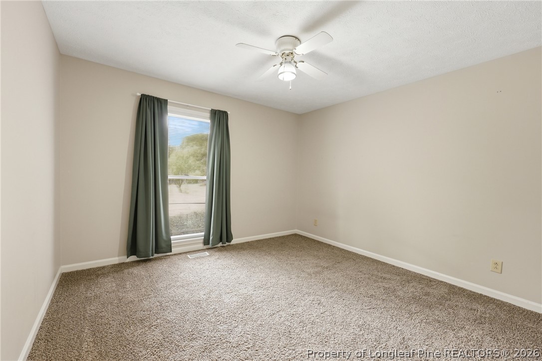 207 Cobblestone Court Raeford, NC 28376 - Photo 19 of 35 an empty room with fan and windows