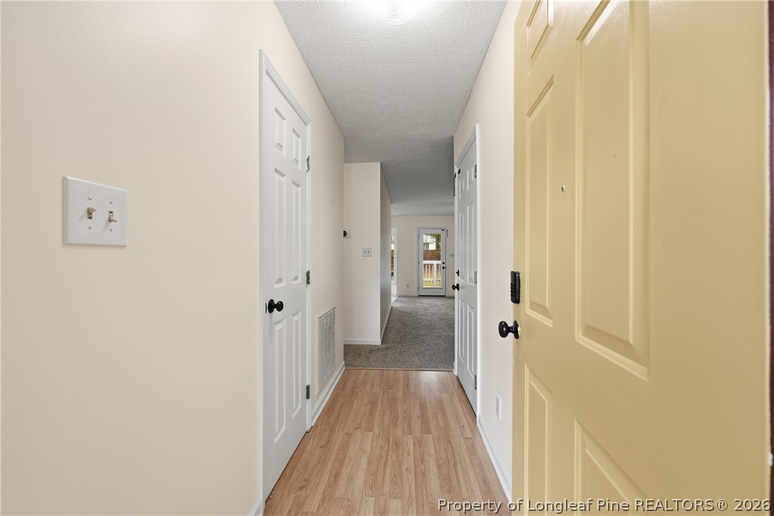 207 Cobblestone Court Raeford, NC 28376 - Photo 26 of 35 a view of a hallway with wooden floor and staircase