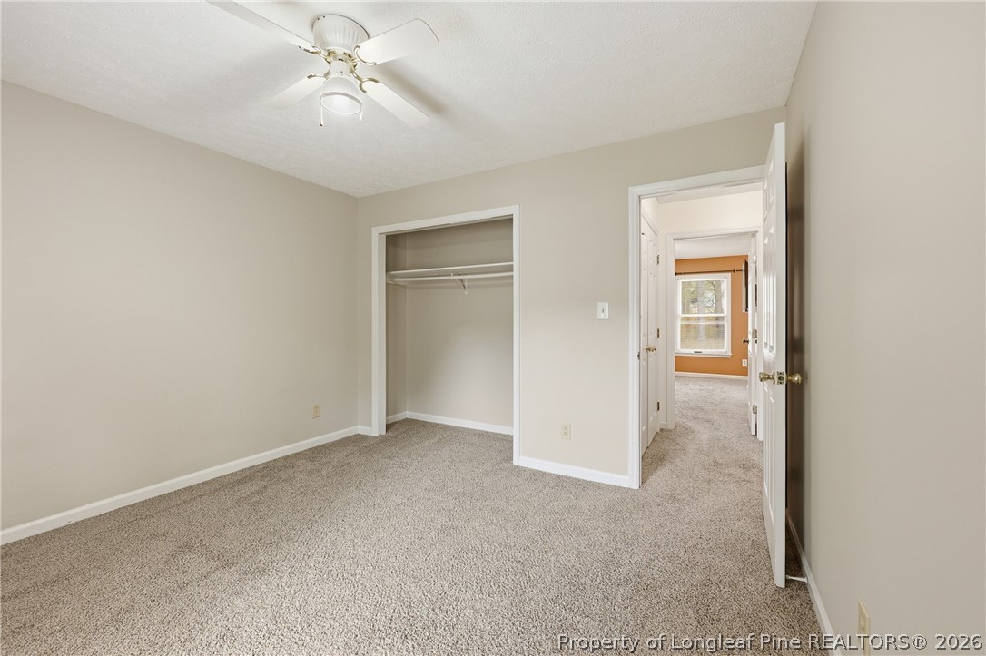 207 Cobblestone Court Raeford, NC 28376 - Photo 28 of 35 an empty room with a ceiling fan and a window