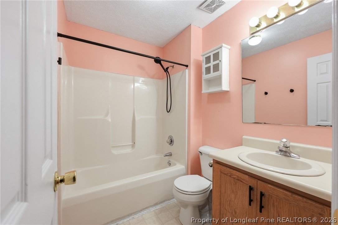 207 Cobblestone Court Raeford, NC 28376 - Photo 30 of 35 a bathroom with a sink toilet and shower