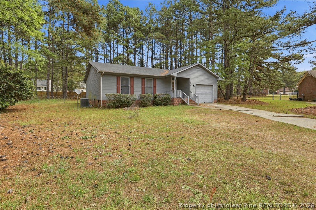 207 Cobblestone Court Raeford, NC 28376 - Photo 5 of 35 a front view of a house with a garden