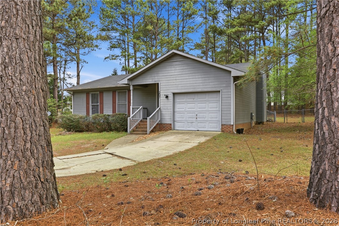 207 Cobblestone Court Raeford, NC 28376 - Photo 8 of 35 a view of garage and yard