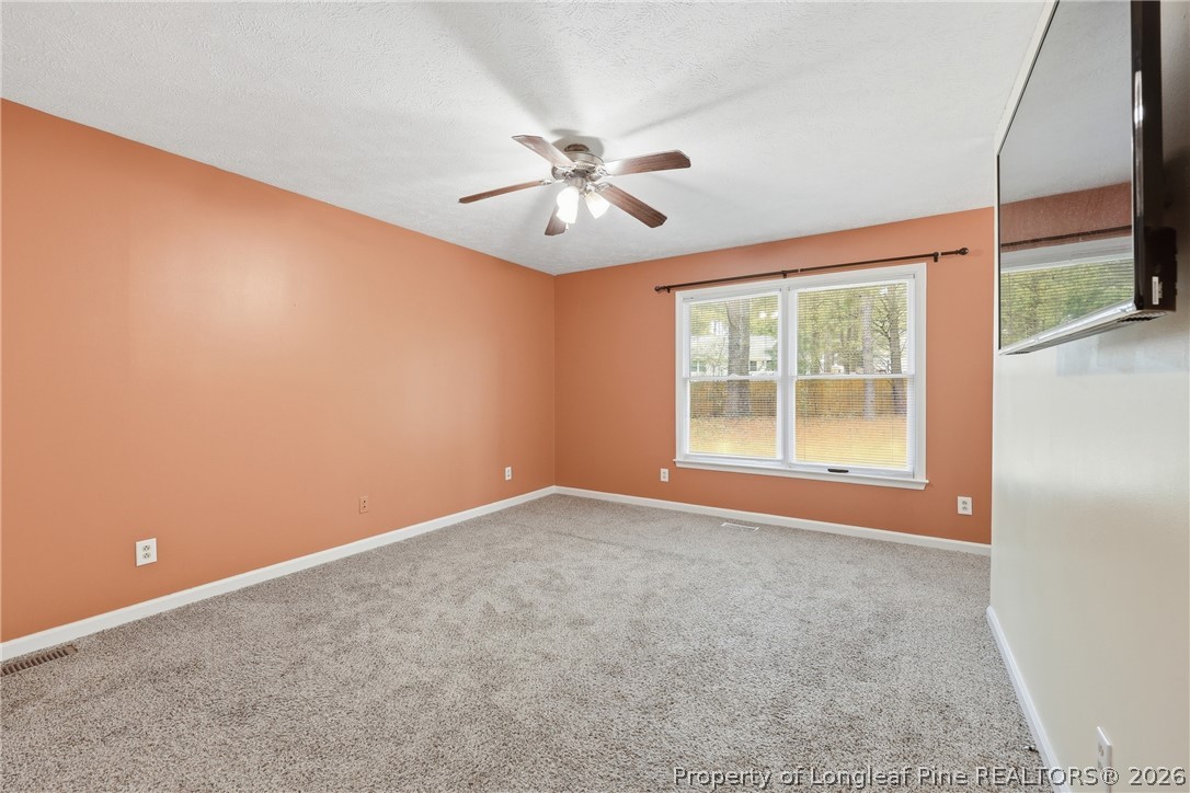 207 Cobblestone Court Raeford, NC 28376 - Photo 10 of 35 an empty room with windows and fan