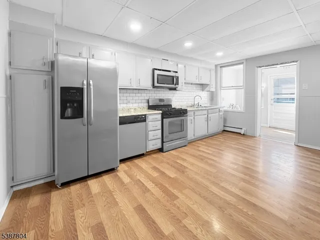 a large kitchen with cabinets and stainless steel appliances