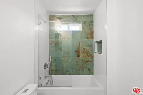 a bathroom with a bathtub and shower