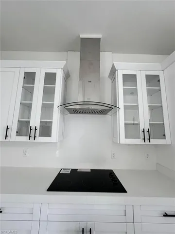 a view of a closet with wooden floor and cabinets