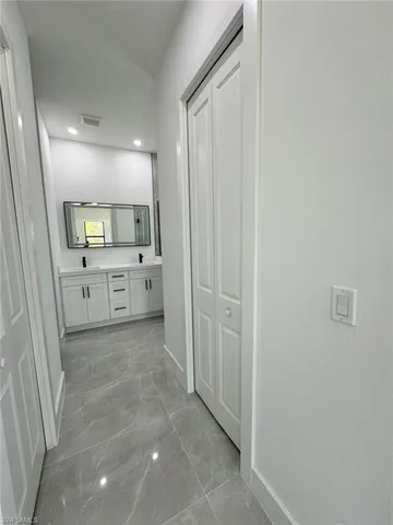 a view of a hallway and a kitchen with a sink