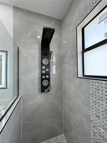 a bathroom with a shower and a sink