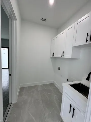 a view of cabinets and refrigerator