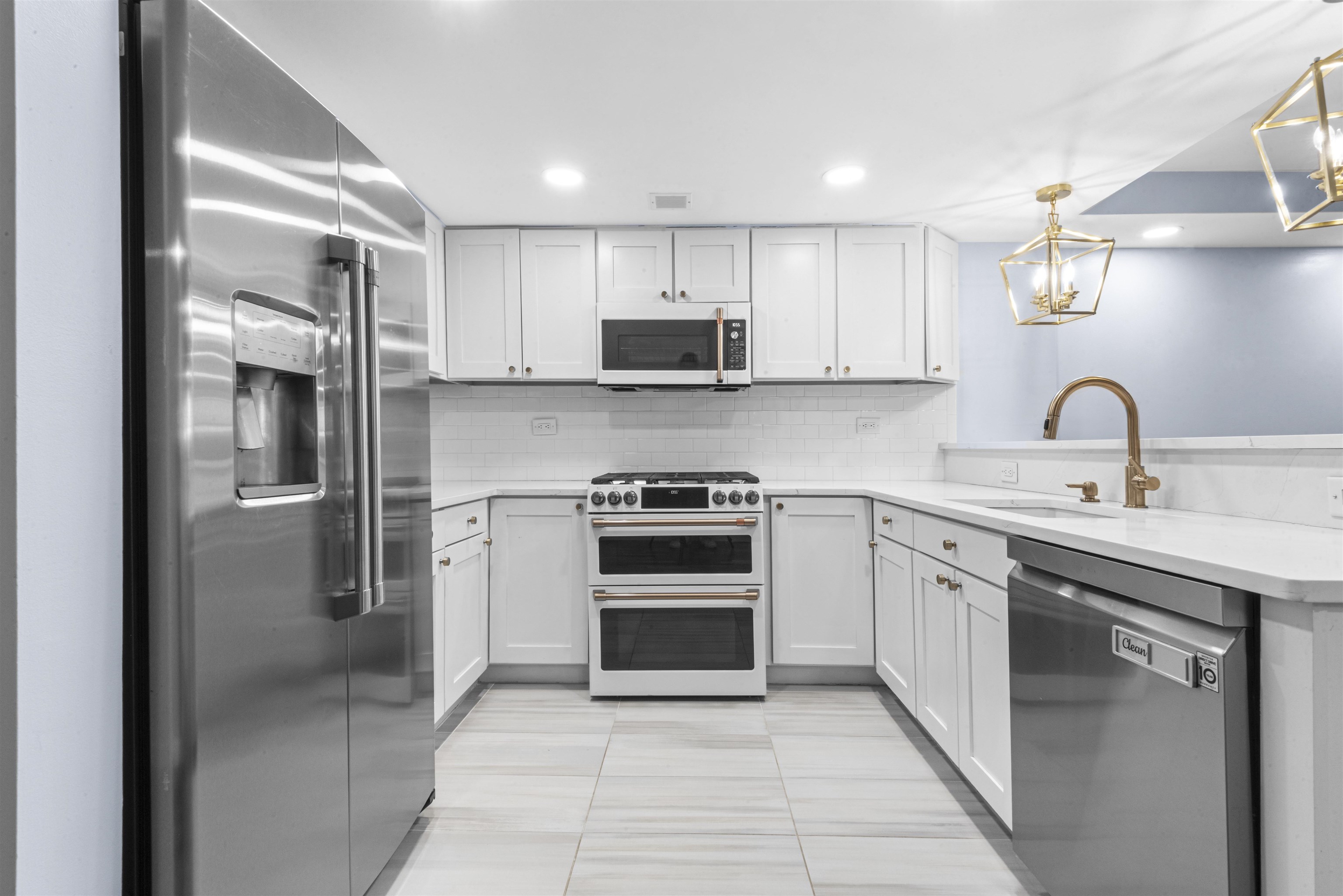 700 1st Street, Unit 5B Hoboken, NJ 07030 - Photo 3 of 14 a kitchen with stainless steel appliances granite countertop a stove and a refrigerator