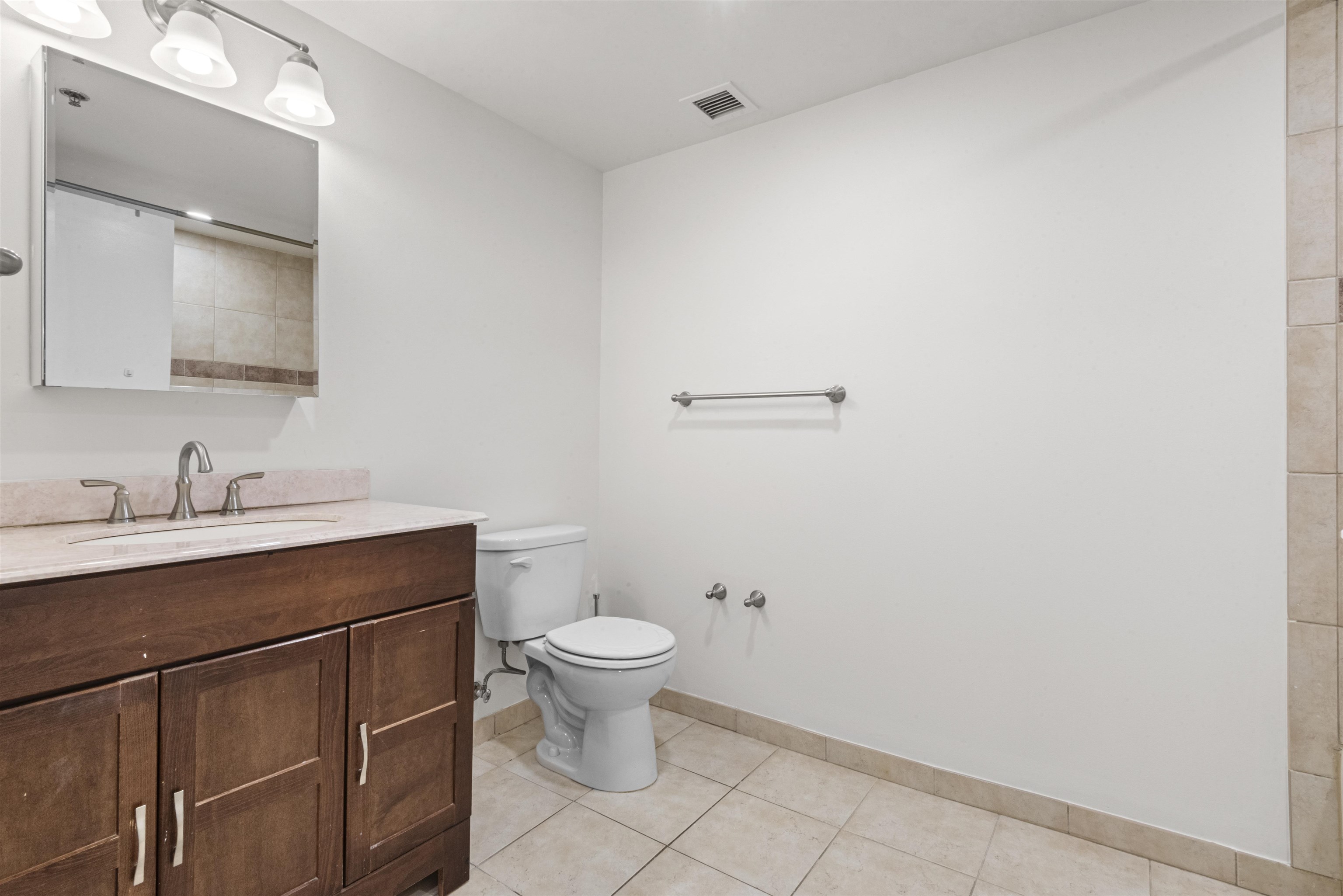 700 1st Street, Unit 5B Hoboken, NJ 07030 - Photo 9 of 14 a bathroom with a sink toilet and vanity