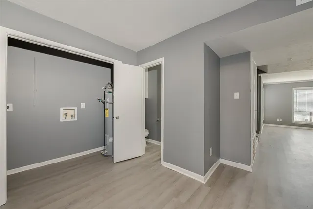 an empty room with wooden floor and closet