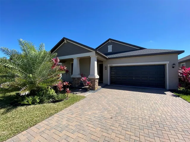 a front view of a house with a yard and garage