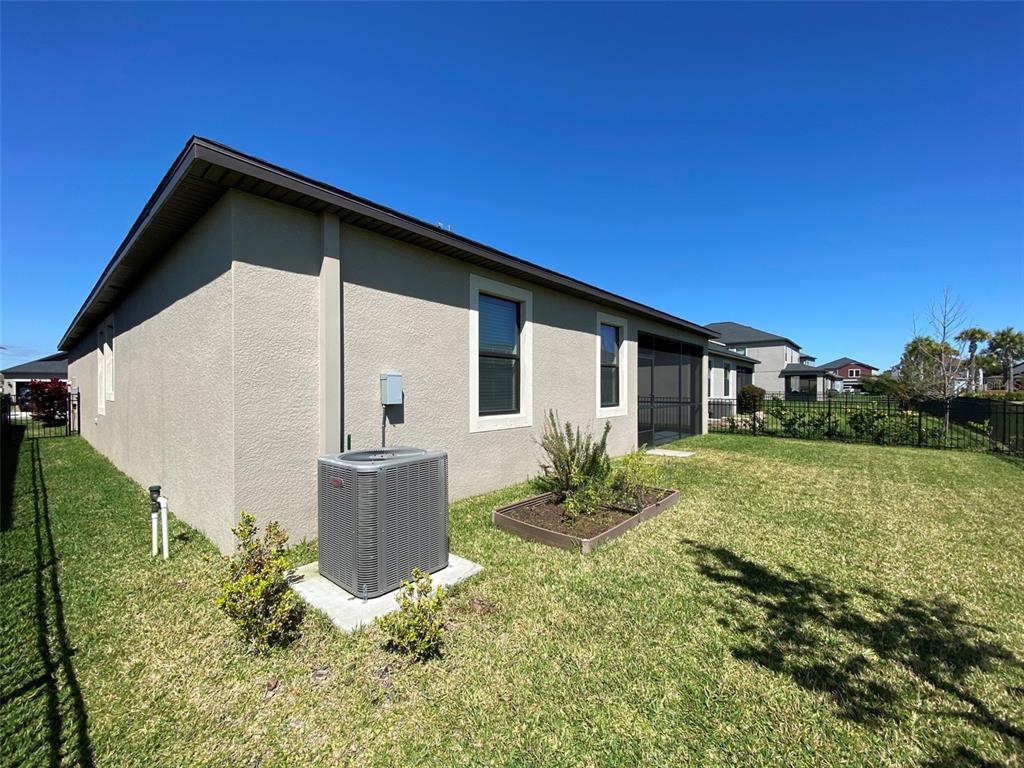10049 Victory Gallop Loop Ruskin, FL 33573 - Photo 21 of 22 a front view of a house with garden