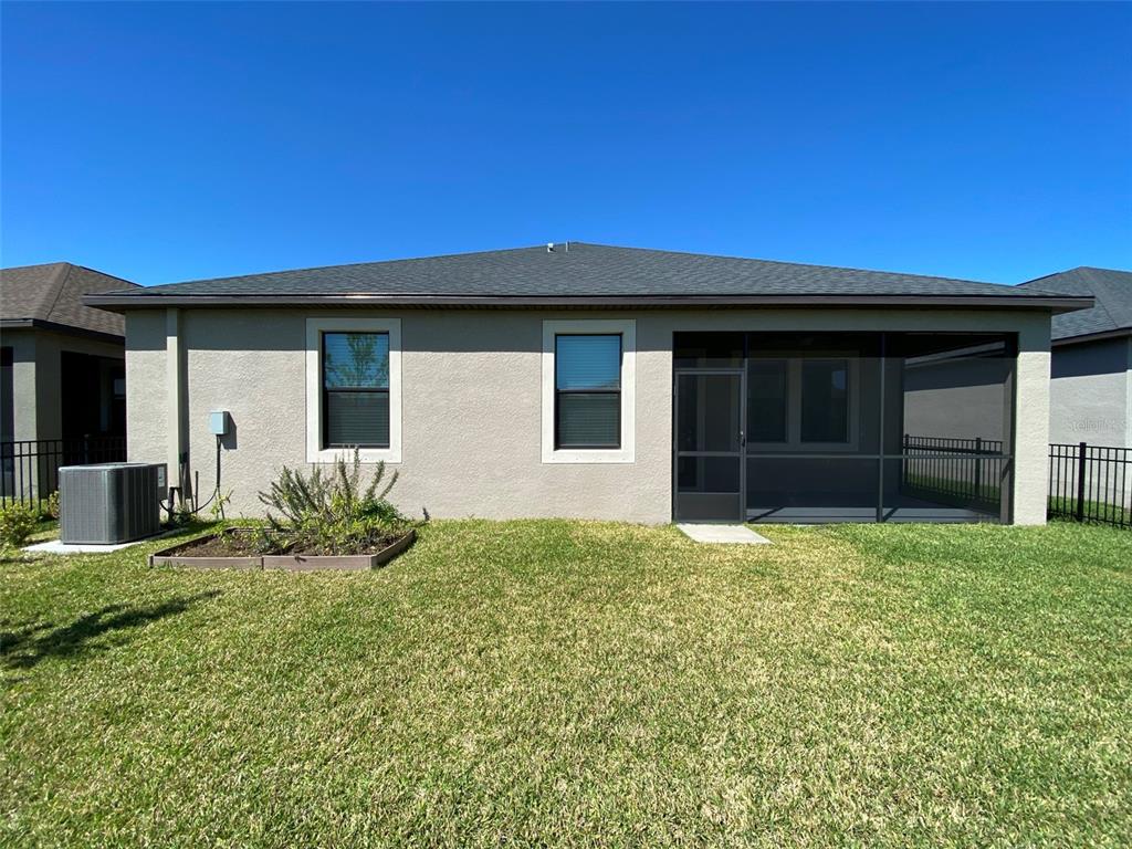 10049 Victory Gallop Loop Ruskin, FL 33573 - Photo 22 of 22 a house that has a big yard and large trees